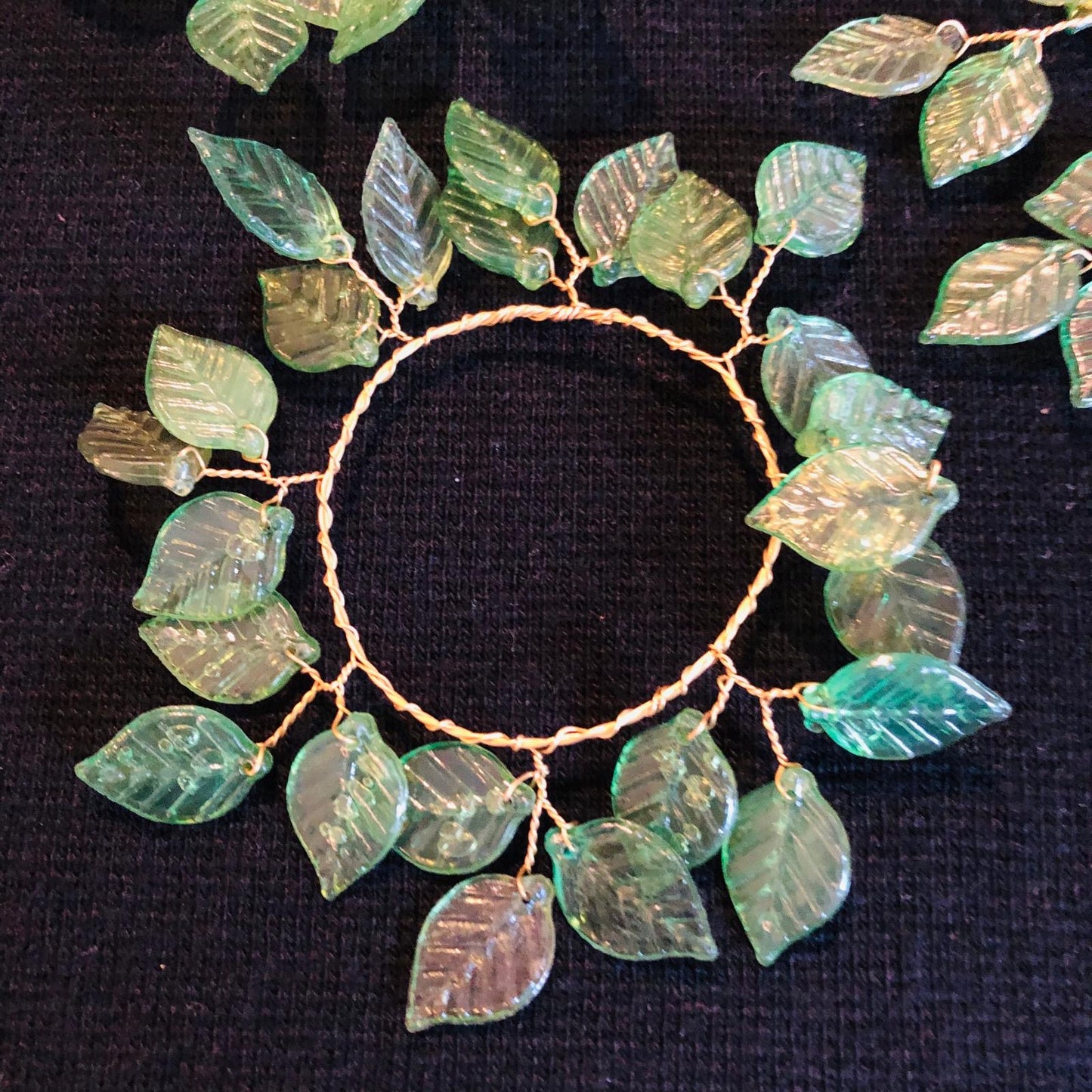 Decorative wreath with leaf-shaped ornaments on a black background