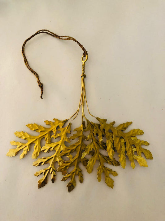 Gold leaf branch decoration on a beige background